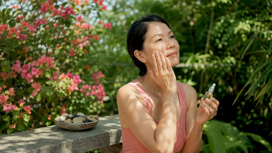 Woman applying Japanese skincare essence in bathroom