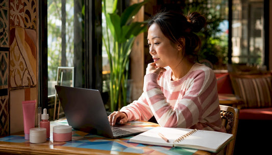 Woman shopping online for beauty products at home desk