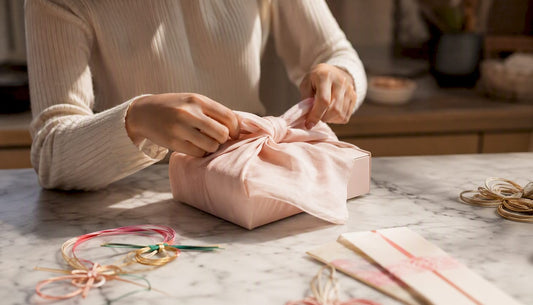 Hands wrapping a Japanese beauty gift with furoshiki cloth