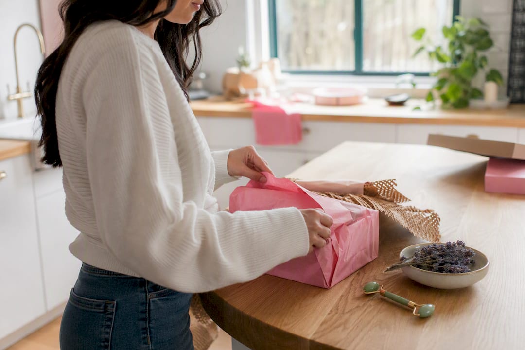 Hands unboxing Asian beauty product on vanity