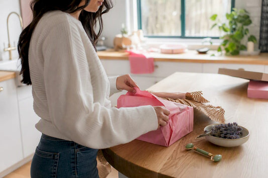 Hands unboxing Asian beauty product on vanity