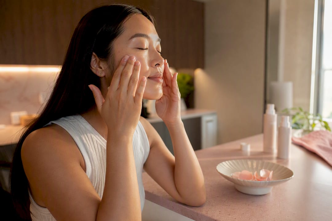 Hands applying essence in Korean skincare routine