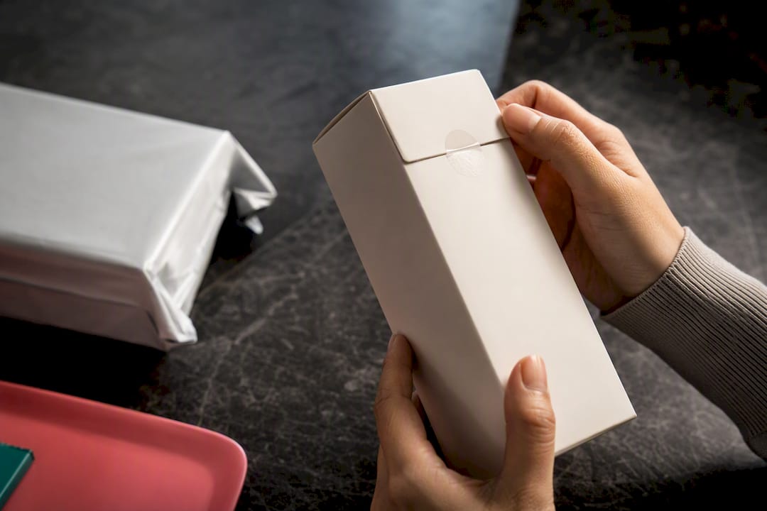 Hands inspecting anonymous skincare packaging